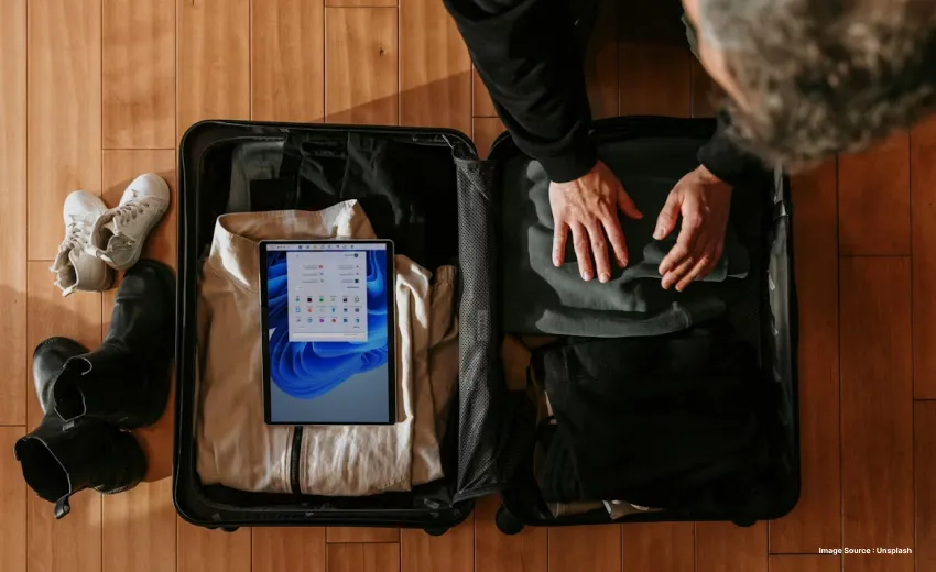 a picture of someone packing a suitcase