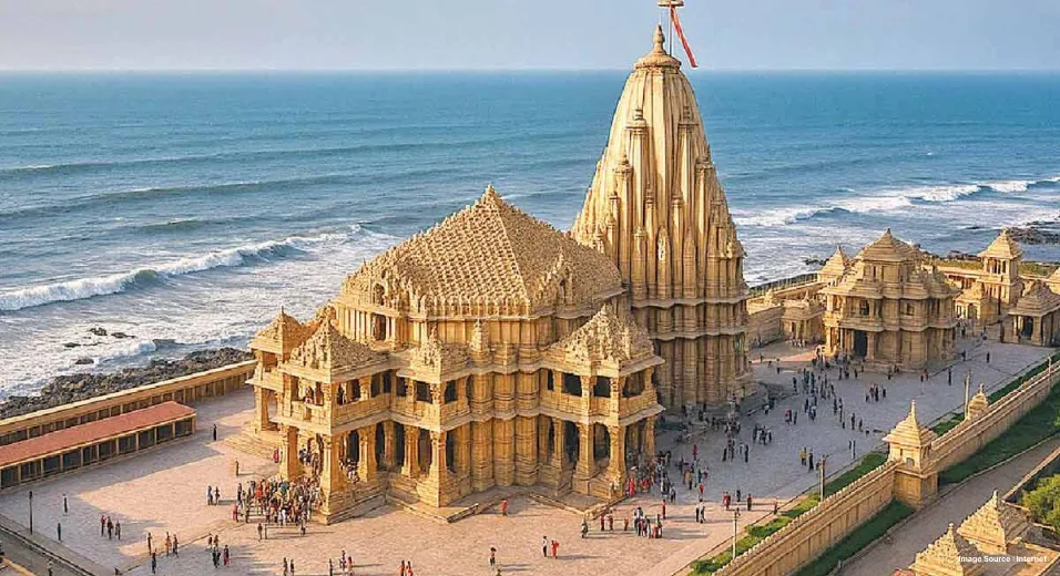 a golden stone temple with intricate carvings located on a shore with devotees entering it
