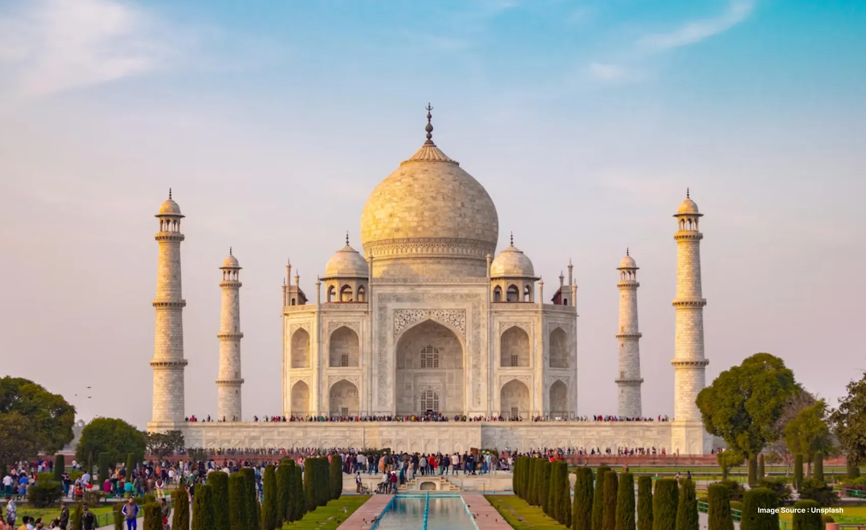 Front view of the breathtaking Taj Mahal as tourists explore it