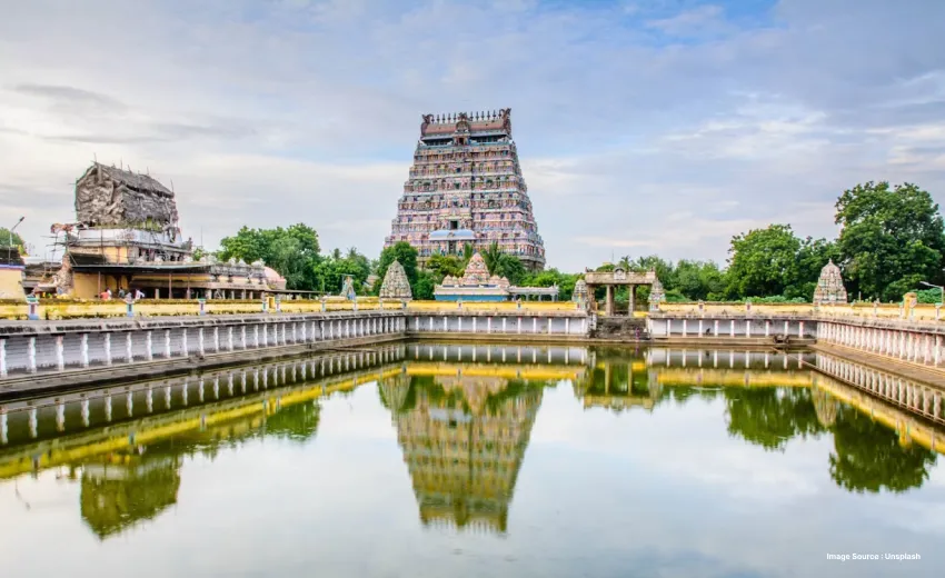an image on a temple structure reflecting in the water