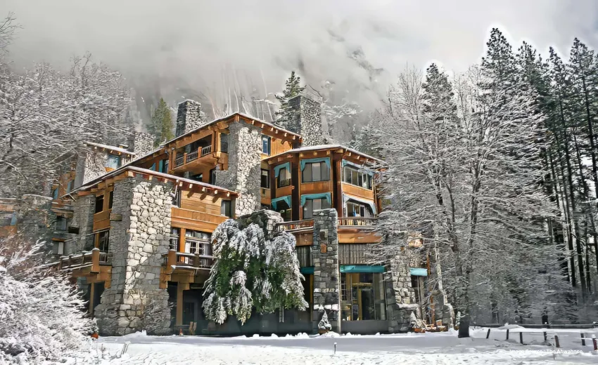the historic ahwanee hotel covered in snow during a snowstorm at yosemite