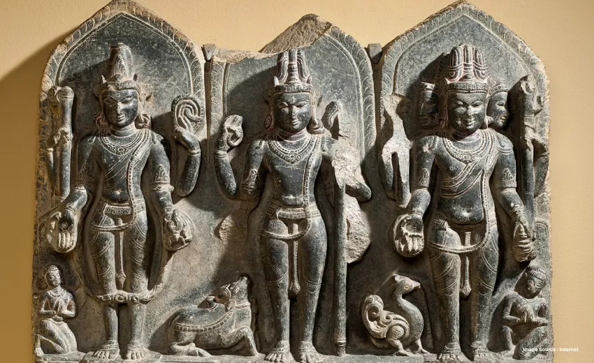 an ancient rock carved idols of hindu lords vishnu, shiva and brahma