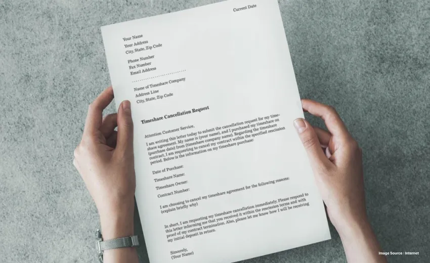 Close up of a timeshare cancellation contract held by a person