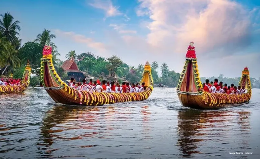 two long snake boats decorated with flowers with many boaters for a race