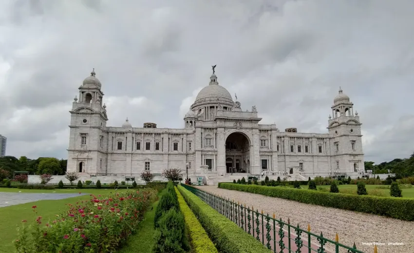 an image of a building with a grey sky surrounded by flowers