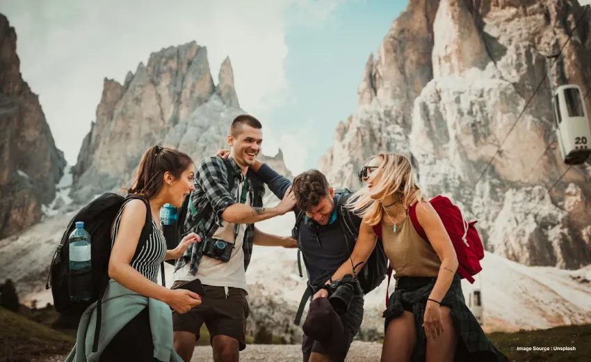 a group of young friends enjoying a trek with mountains in the background