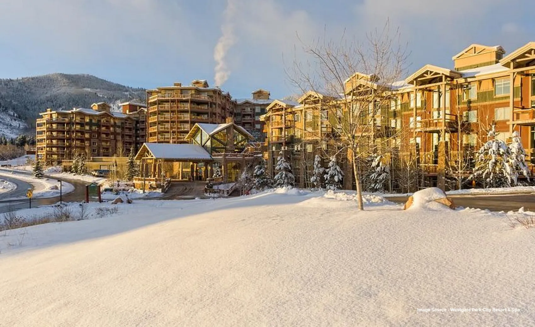 a daytime view of the snow covered westgate park city resort with wooden buildings