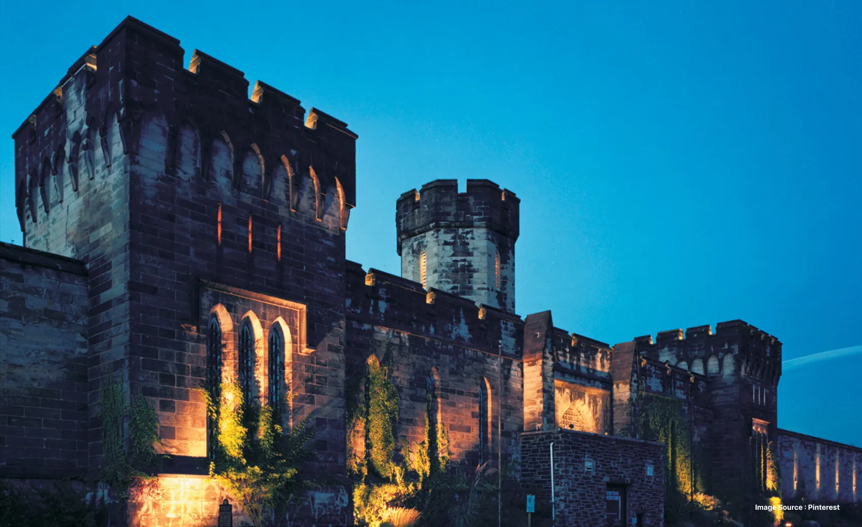 haunted looking palace with lit up walls during dusk