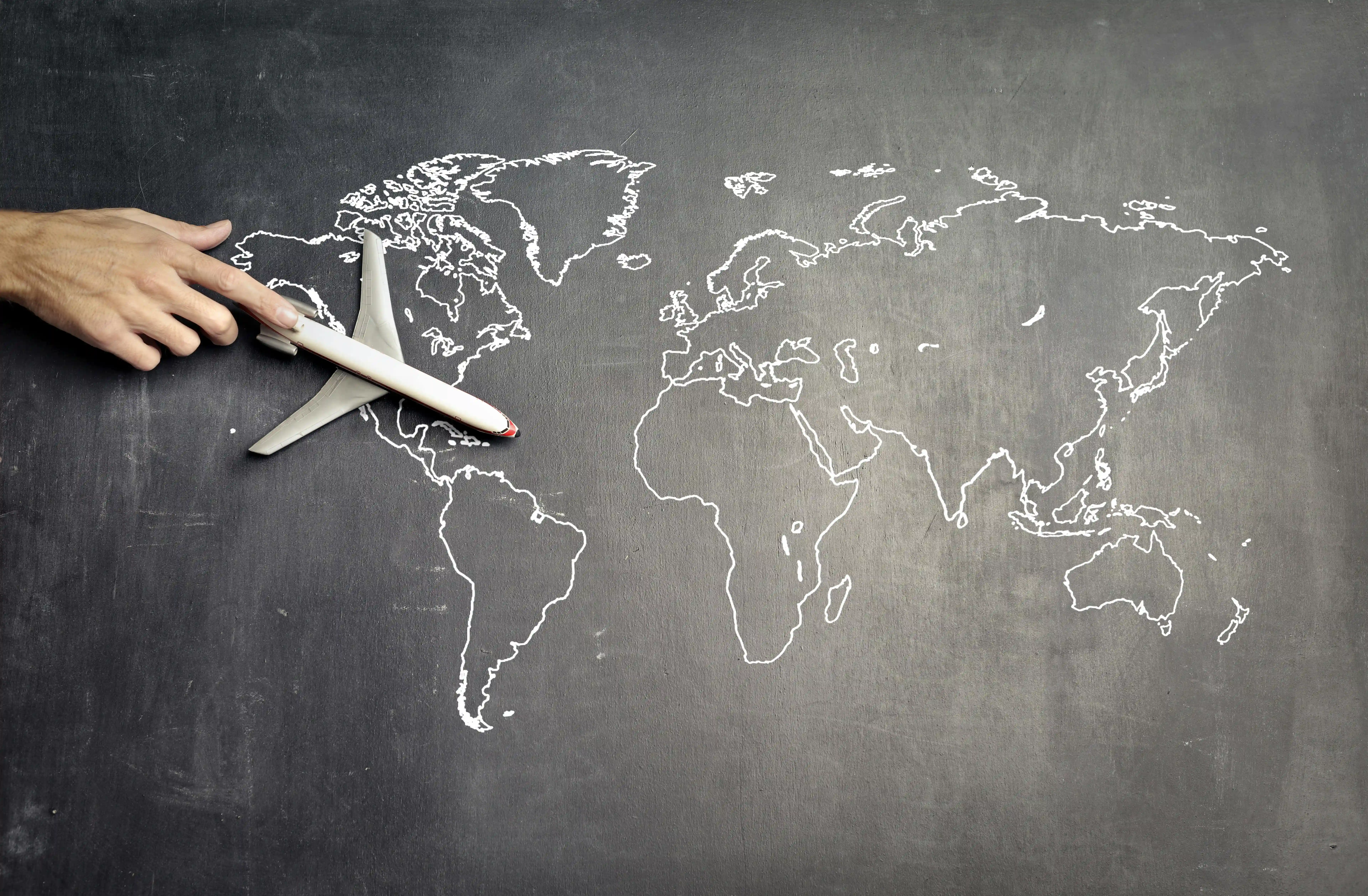 world map drawn with chalk on a black board