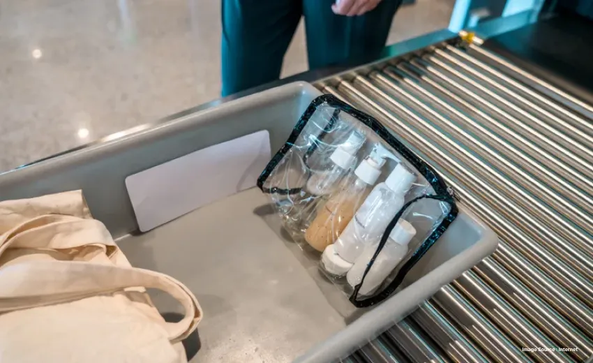 A gray tray at the airport, security scan with a clear bag of liquid bottles