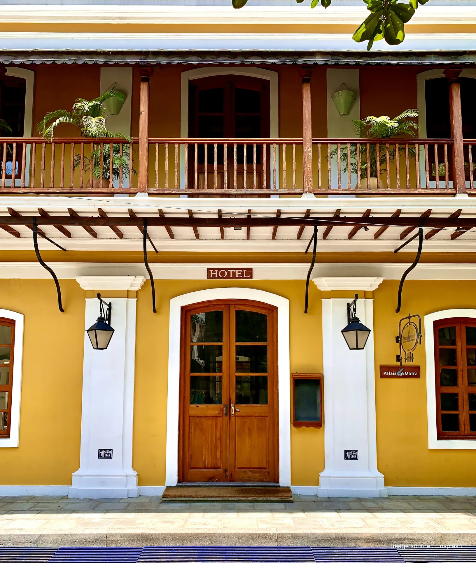 front view of a building in the french quarter of puducherry painted in yellow