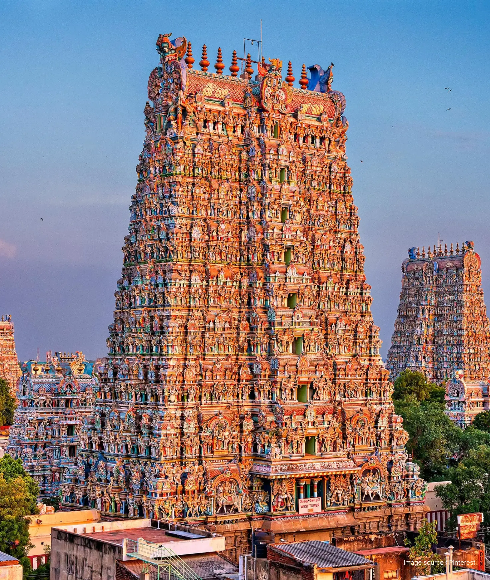 aerial shot of the meenakshi amman temple's towering gopuram with intricate colorful sculptures