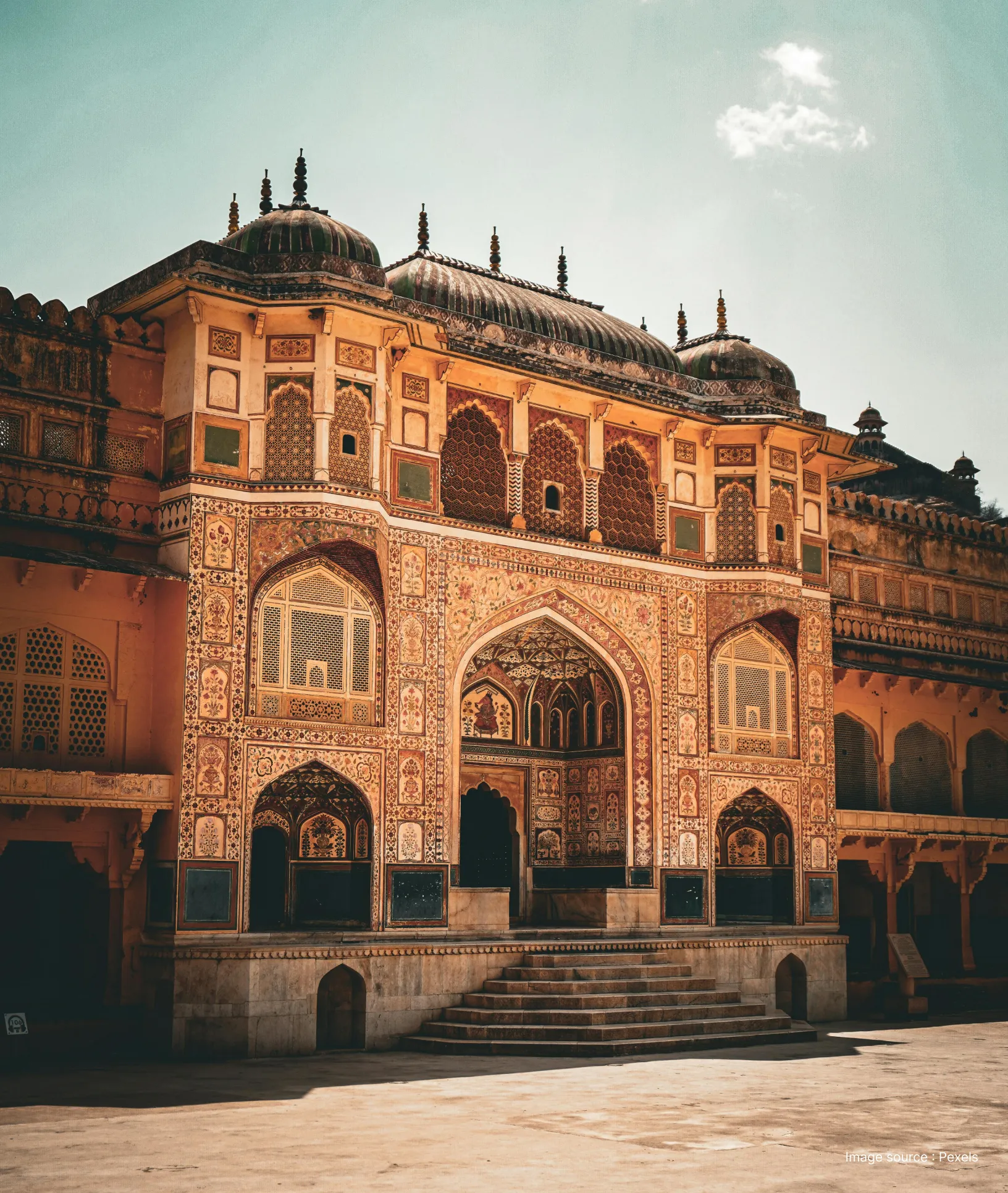 side view of a colorfully painted palace within the amer fort in jaipur