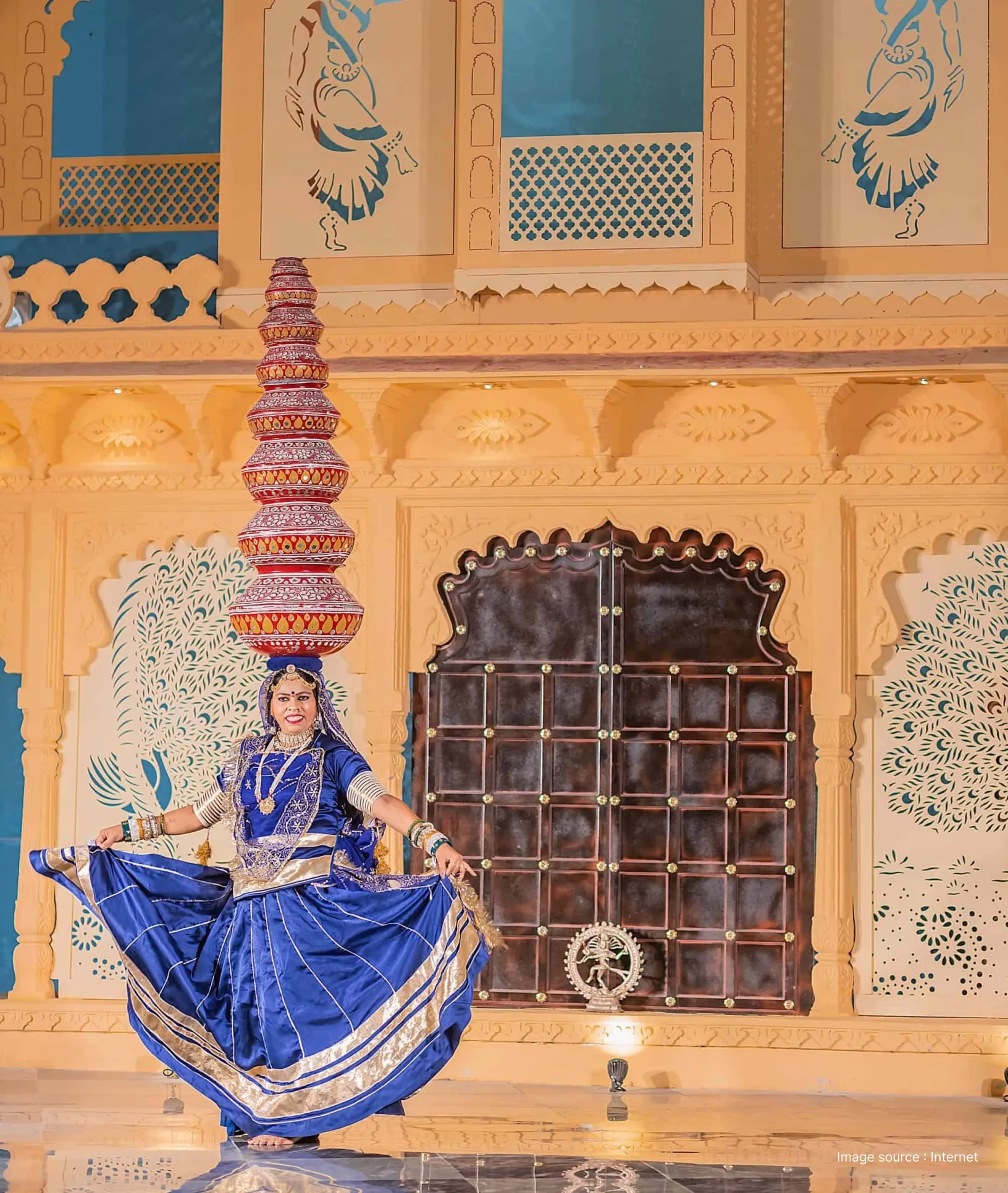 a traditionally dressed woman performs a dramatic folk dance with pots balanced on her head