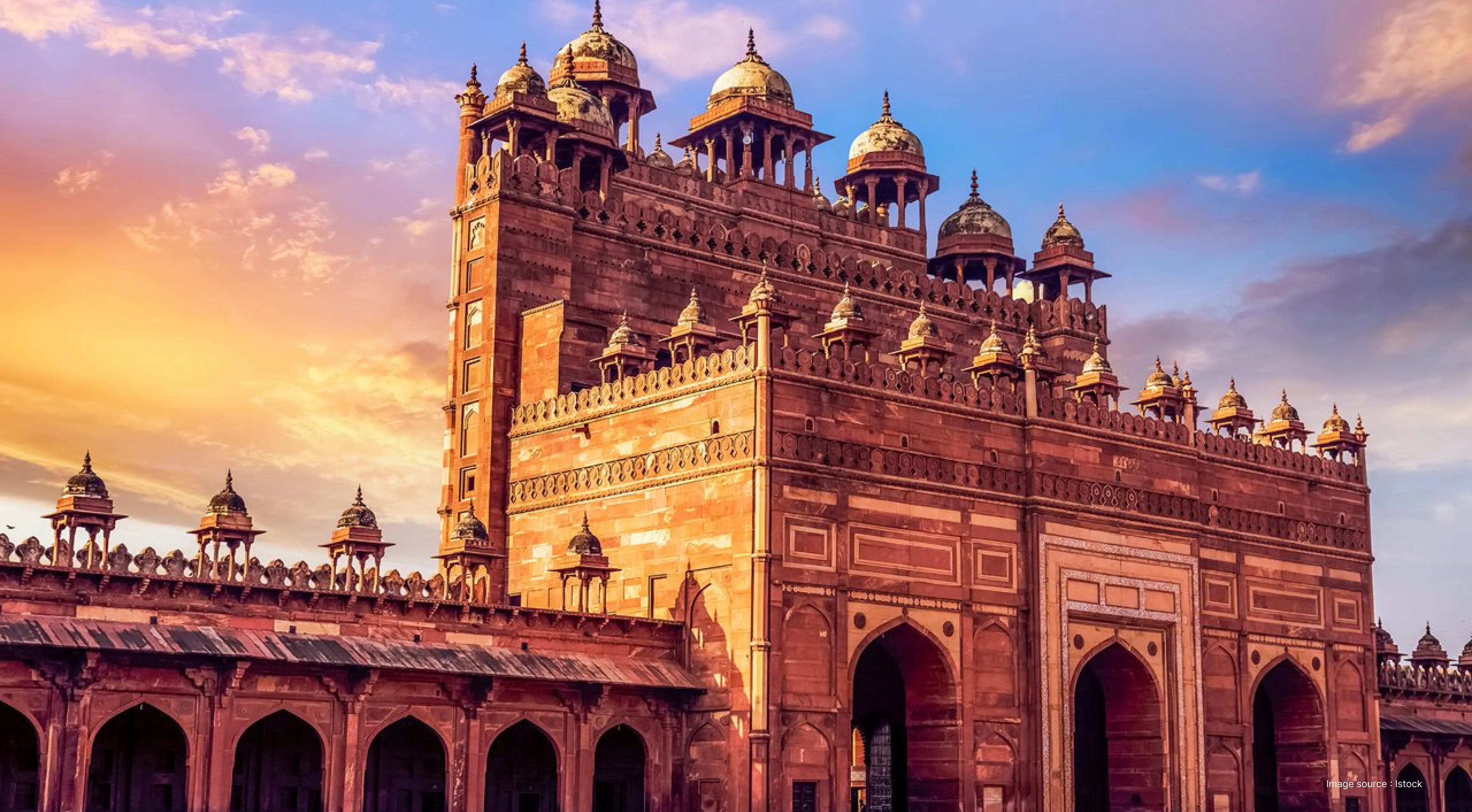 side angled view of the great red gate in fatehpur sikri at sunset
