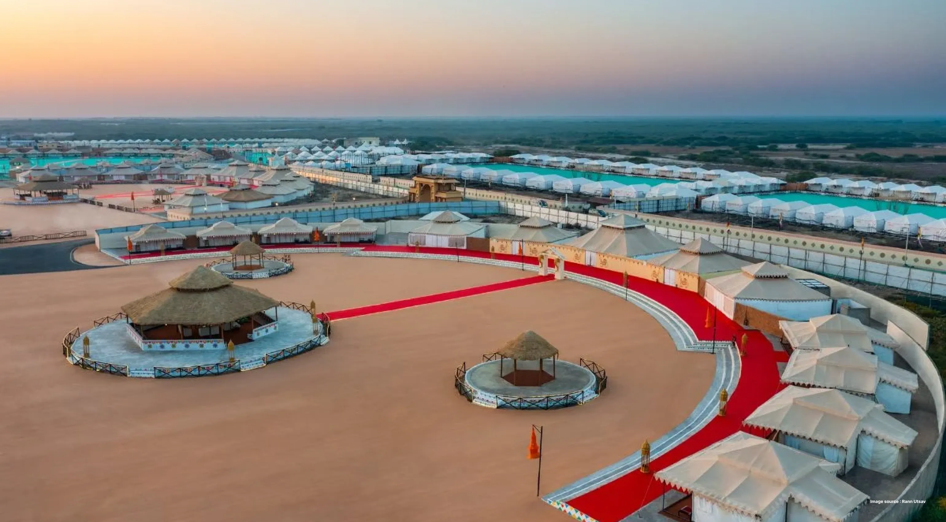 aerial sunset shot of rann utsav's tent accommodation with tents lined up in a circle