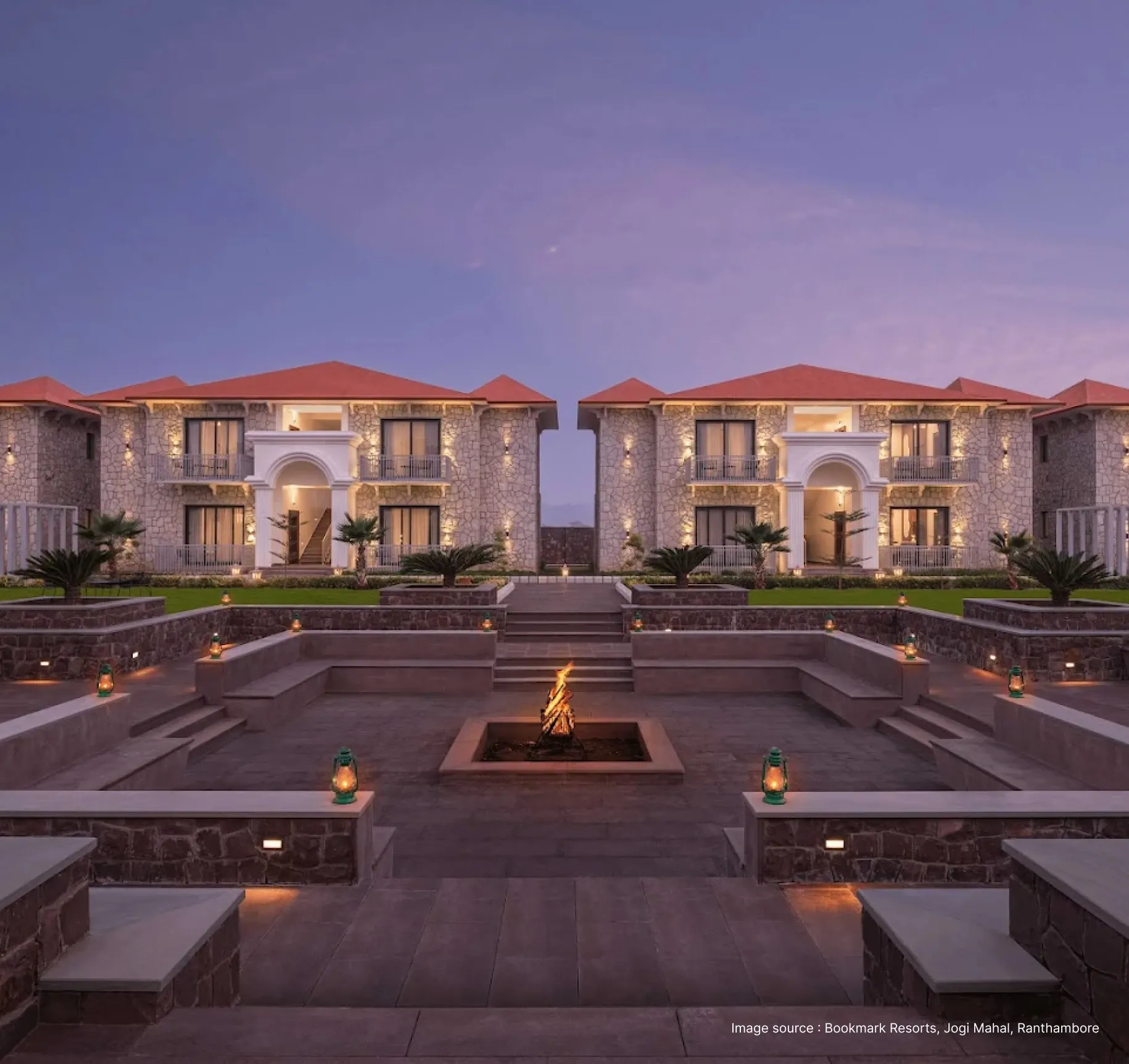 sunset view of bookmark resorts with a view of their lounge area with bonfire