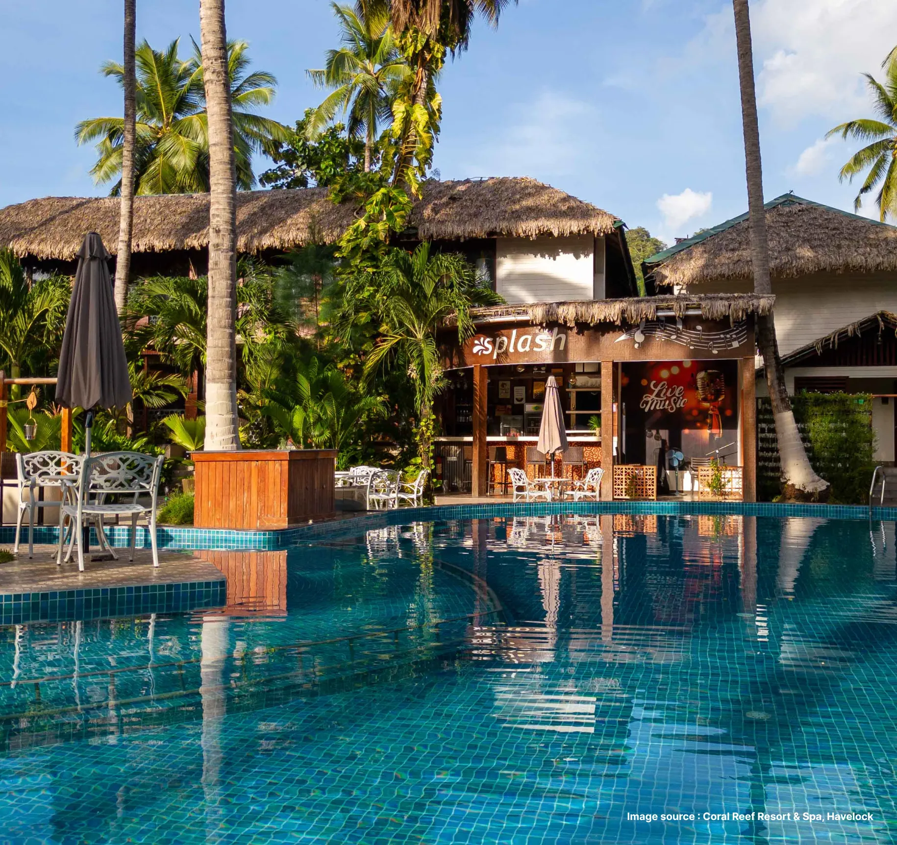 poolside view of the coral reef resort with palm trees