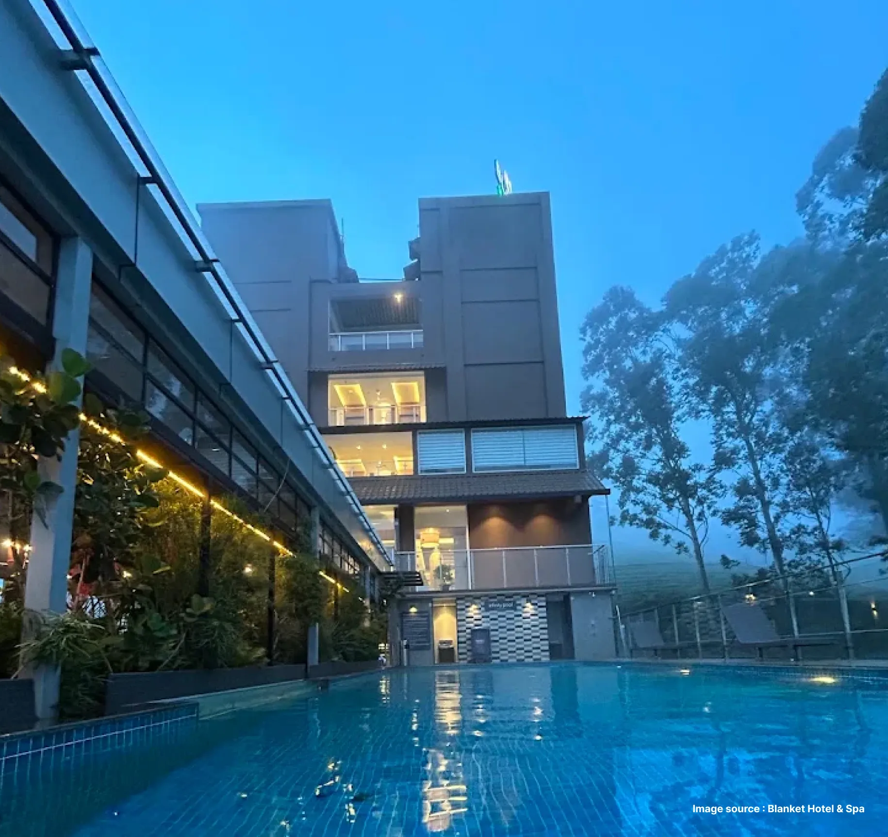 misty evening by the pool at the blanket hotel in munnar