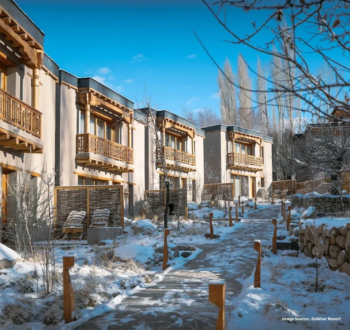 a mountain resort painted in white with ground covered in snow