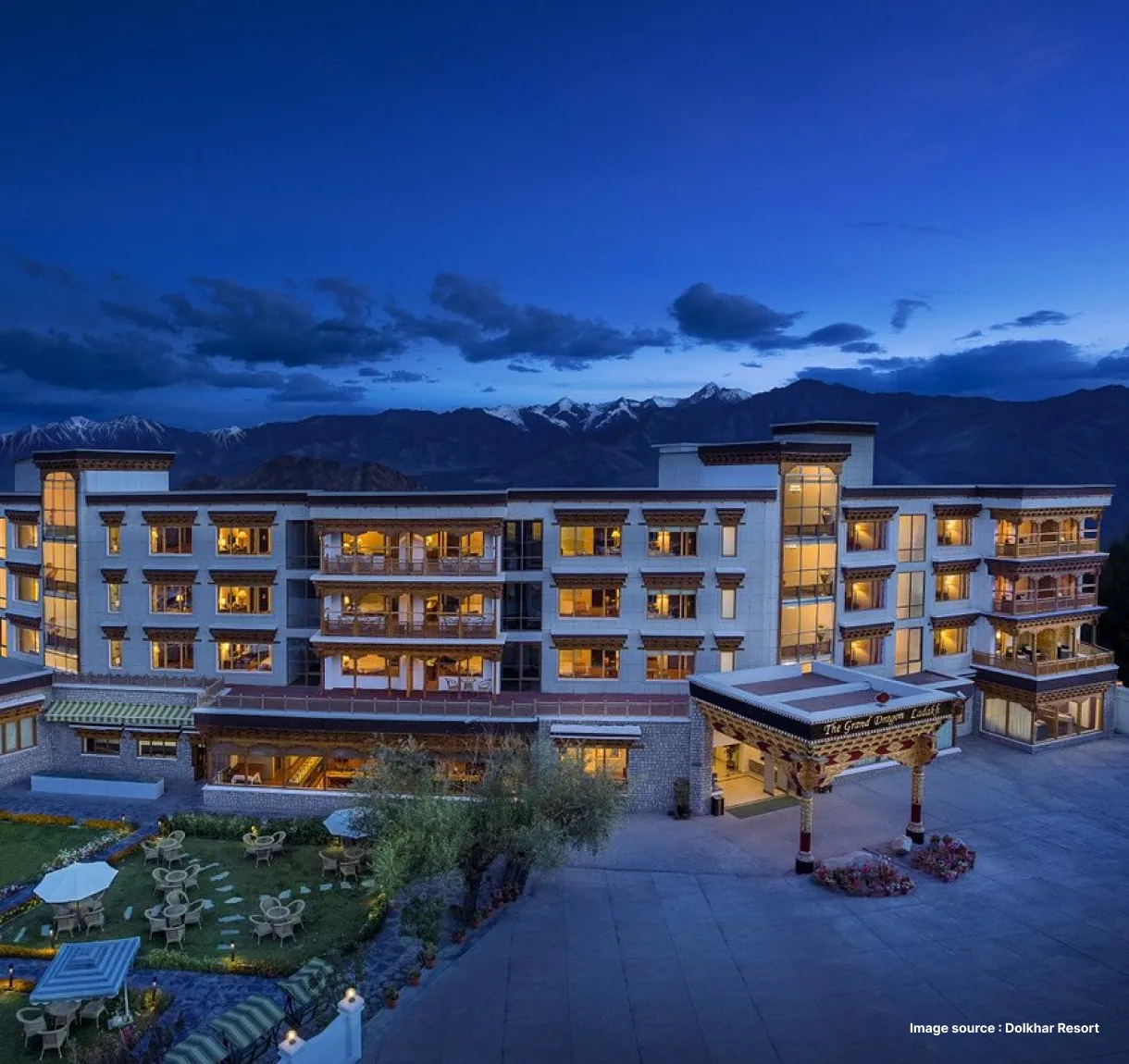 night view of the dolkhar resort with lit up rooms in a white building