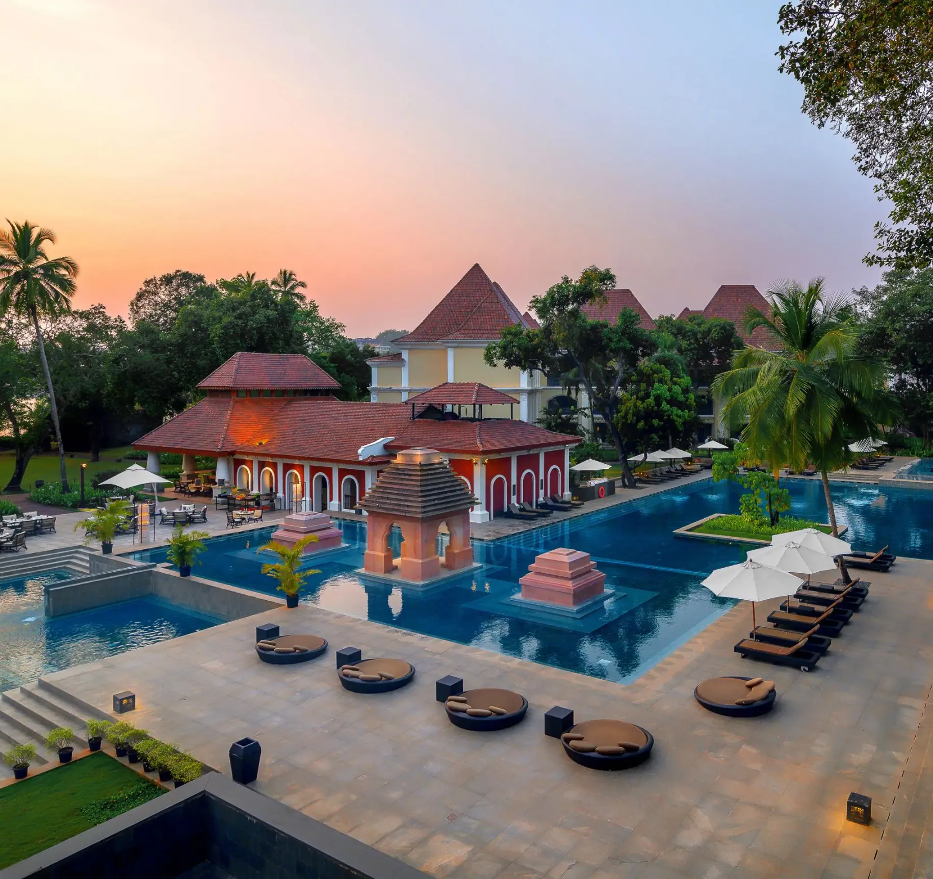 pool view with round lounge chairs at sunset of the grand hyatt goa