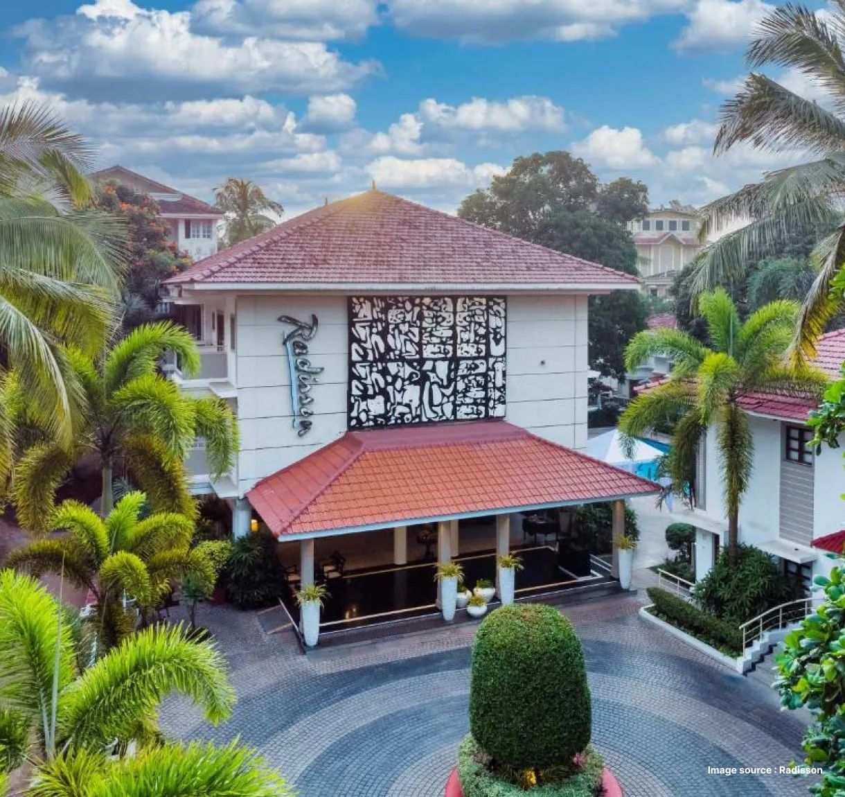 villa style stay of radisson hotel in goa surrounded by palm trees