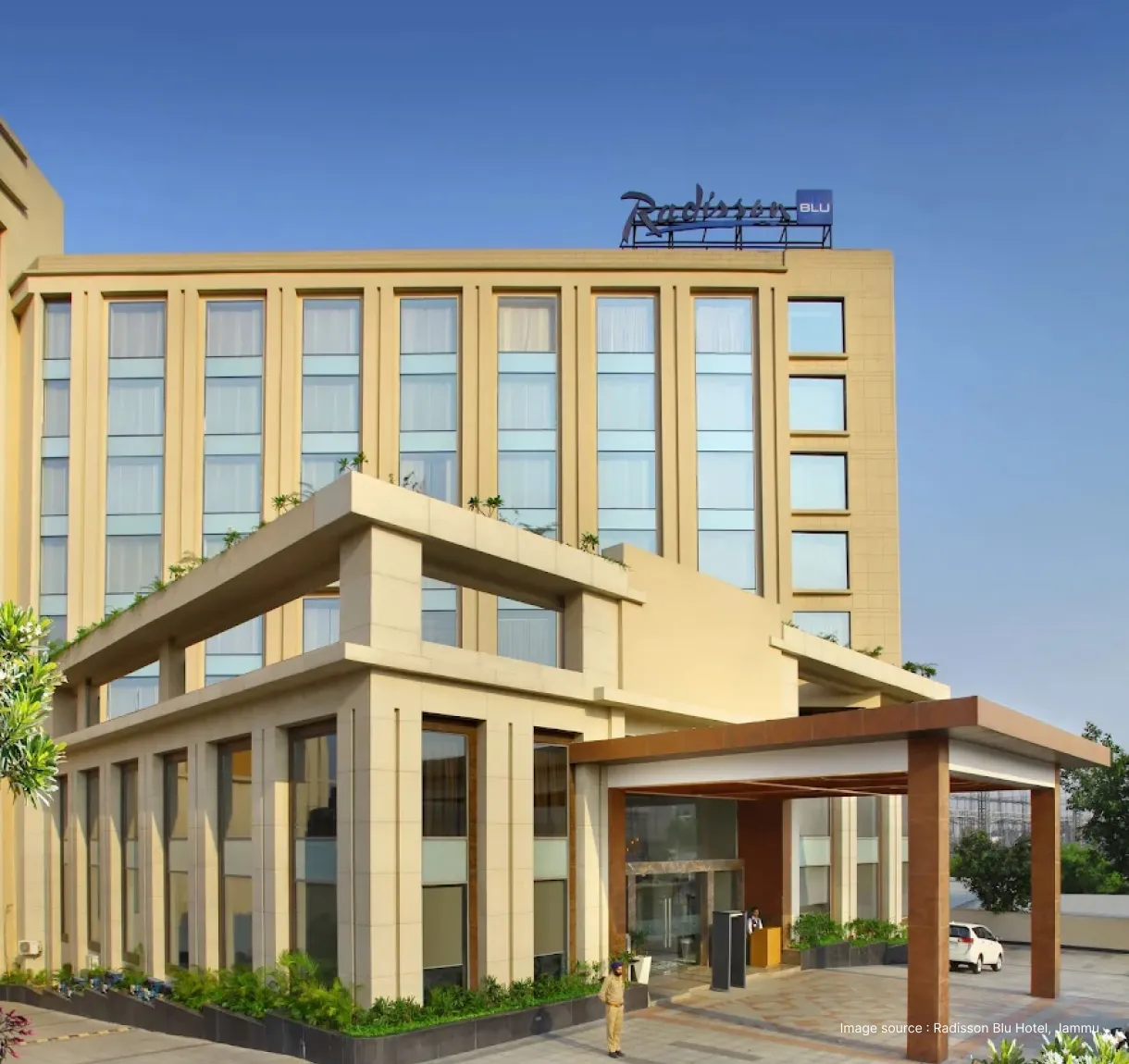 entrance of the radisson blu hotel in jammu with a porch
