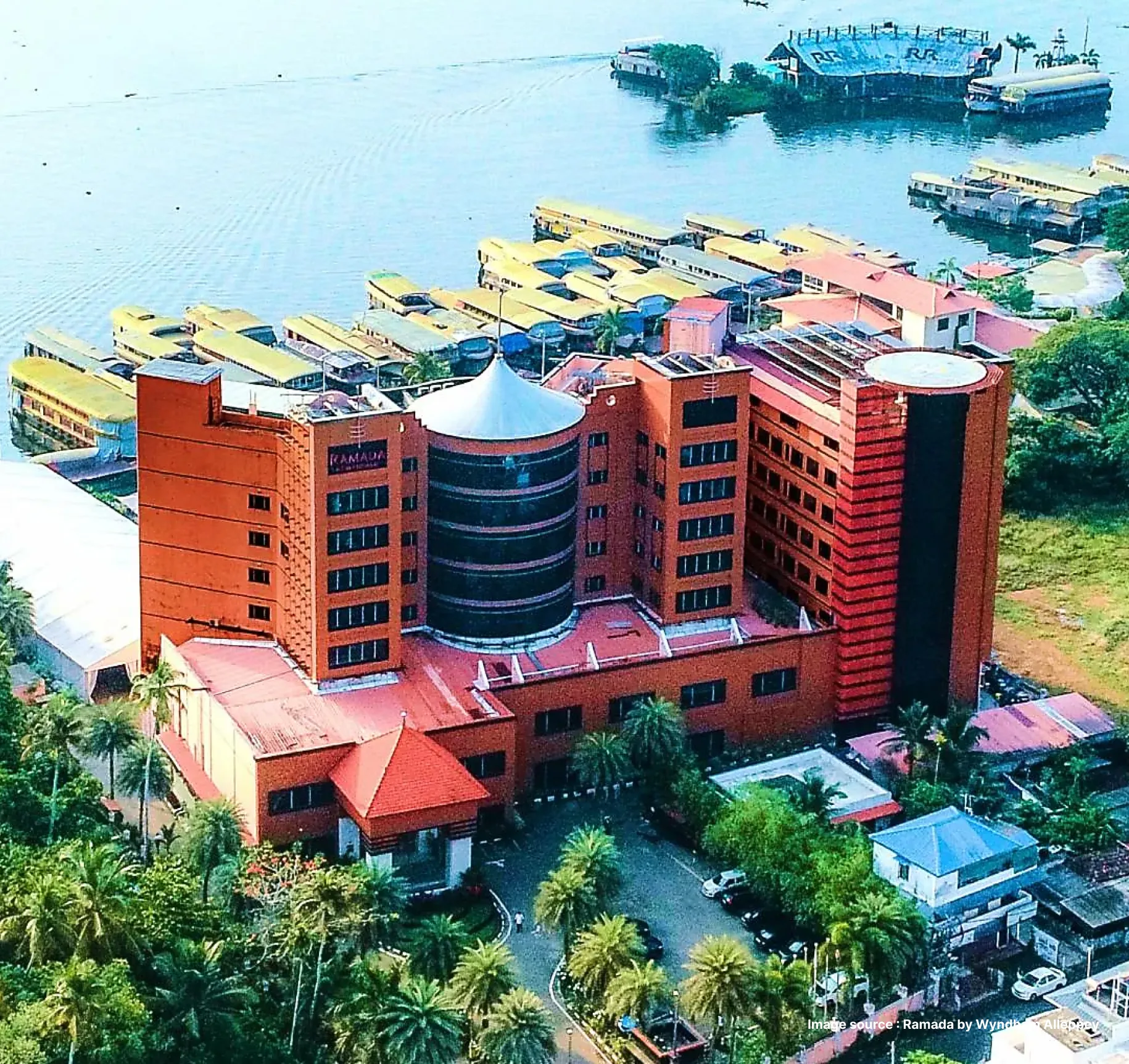 an aerial view of the modern Ramada by Wyndham hotel in alleppey, located on the shore of the Arabian Sea