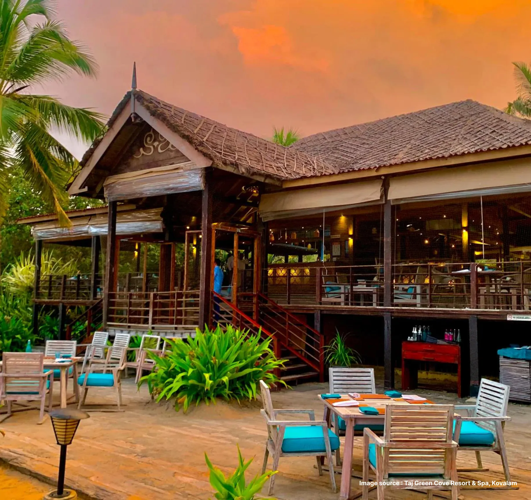 side view of the traditional cottage style rooftop of the taj green cove resort's dining setup