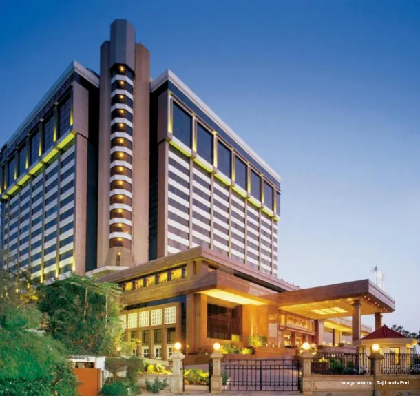 A hotel standing during the evening with it's lights on