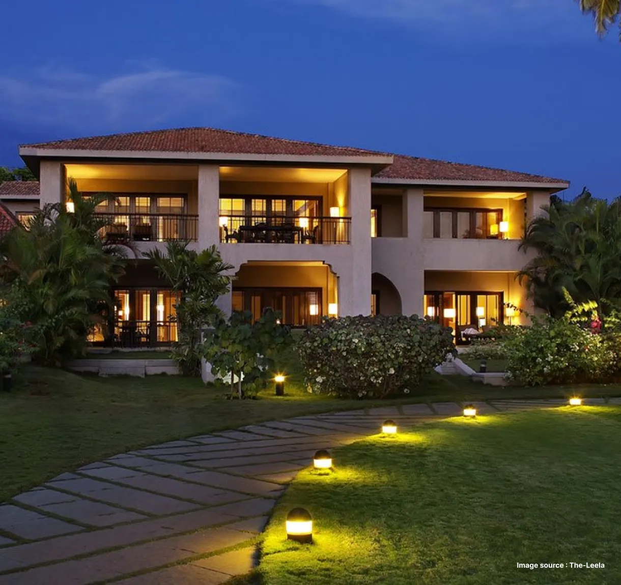 night view of the lit up leela goa stay with a walkway