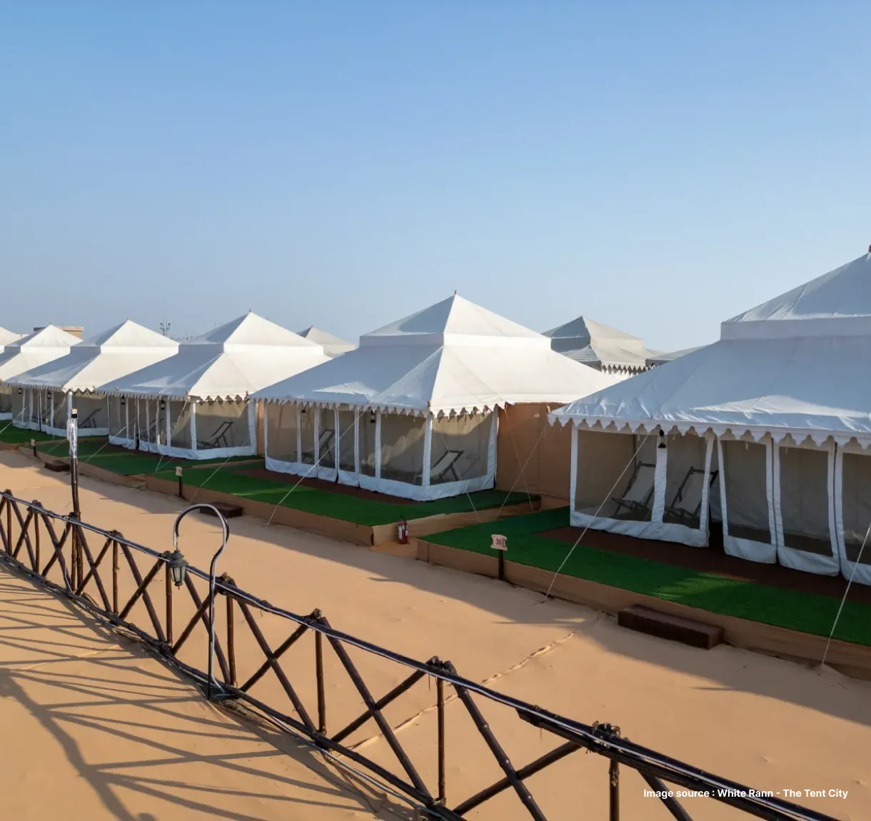 white canvased tents lined up on beige carpets