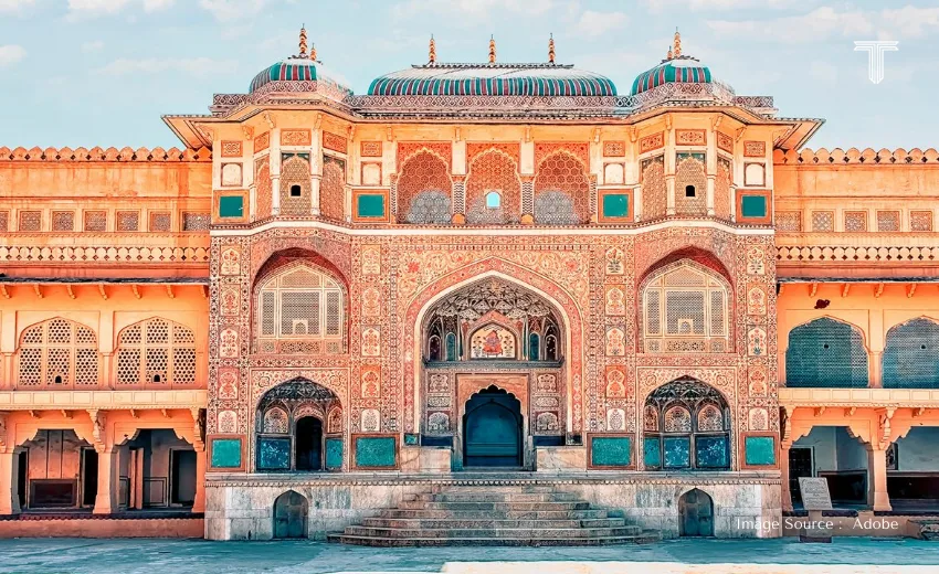 A luxury traveler admiring the Taj Mahal at sunrise, part of an exclusive golden triangle itinerary 7 days.