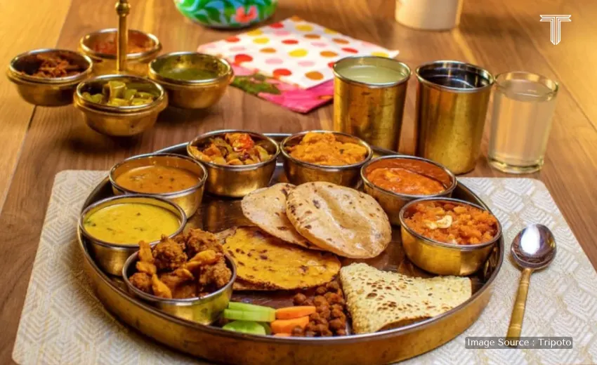 A cinematic shot of a luxury dining in Jaipur, Rajasthani cuisine served on a table